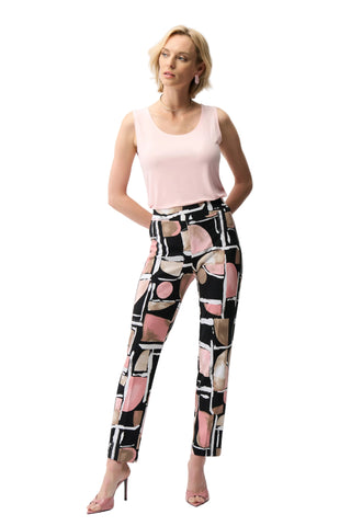 Woman wearing a sleeveless top and patterned pants on a white background