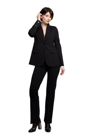 Woman wearing a black suit on a gray background