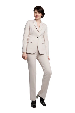 Woman wearing a beige suit on a white background