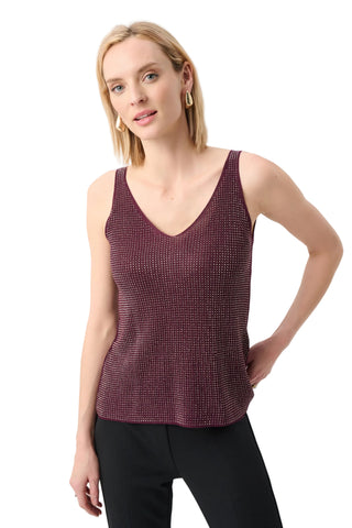 Woman wearing a maroon tank top against a white background