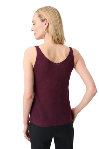 Woman wearing a burgundy tank top against a light gray background