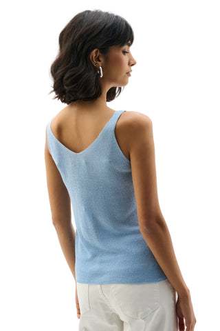 Woman wearing a light blue sleeveless top on a white background