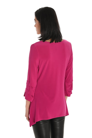 Woman wearing a bright pink long-sleeve top on a white background