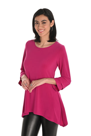 Woman wearing a bright pink top with a white background