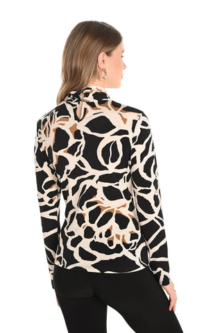 Woman wearing a black and beige patterned blouse on a white background