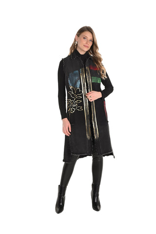 Woman wearing a long black coat with a colorful scarf on a white background