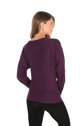 Woman wearing a purple long-sleeve top on a white background