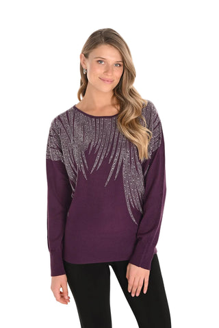 Woman wearing a purple long-sleeve top with decorative patterns on a white background