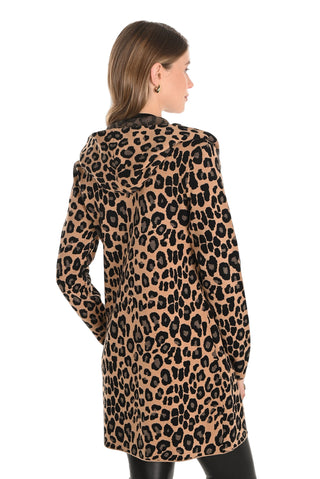 Woman wearing a leopard print coat on a white background