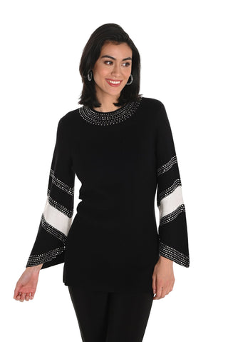 Woman wearing a black sweater with white and gray pattern on a white background
