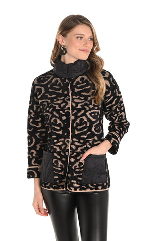 Woman wearing a leopard print jacket with black accents on a white background