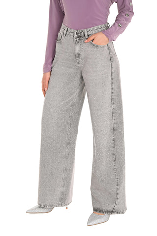 Person wearing light gray wide-leg jeans and a purple top on a white background