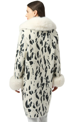 Woman wearing a leopard print coat with white fur trim on a white background