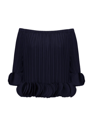 Navy pleated skirt with ruffled bottom on a light gray background