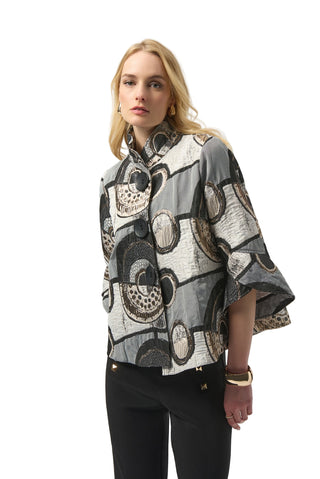 Woman wearing a patterned jacket on a white background