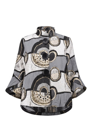 Patterned poncho with black, white, and gold design on a white background
