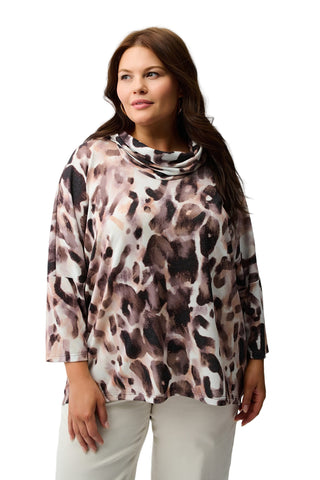 Woman wearing a leopard print top against a white background