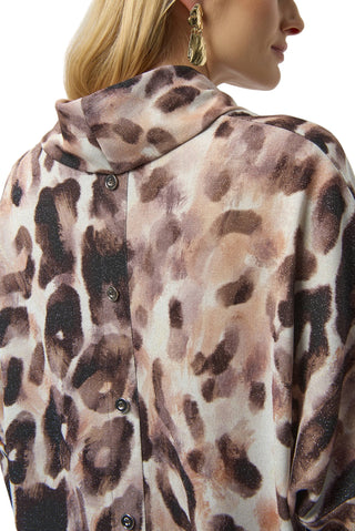 Person wearing a leopard print shirt with a neutral background