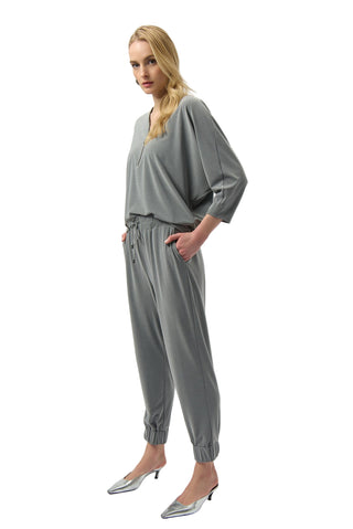 Woman wearing a gray outfit on a white background