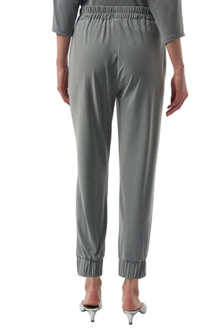 Gray pants worn by a person on a white background