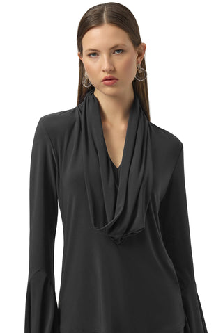 Woman wearing a black long-sleeve top with a draped neckline on a white background