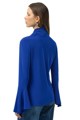 Woman wearing a blue long-sleeve top on a white background