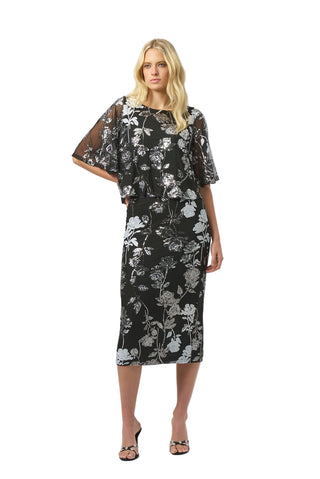 Woman wearing a black floral dress on a white background