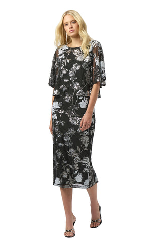 Woman wearing a black floral dress on a white background