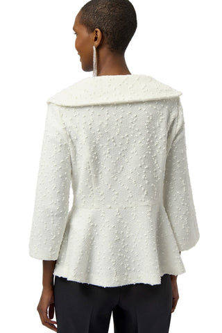 Woman wearing a textured white jacket on a plain background