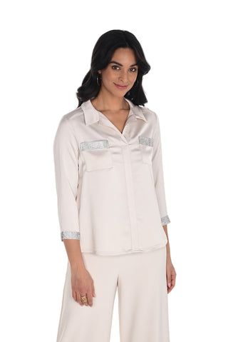 Woman wearing a light-colored outfit with a white background
