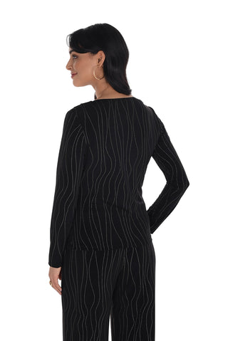 Woman wearing a black outfit with white patterns on a white background