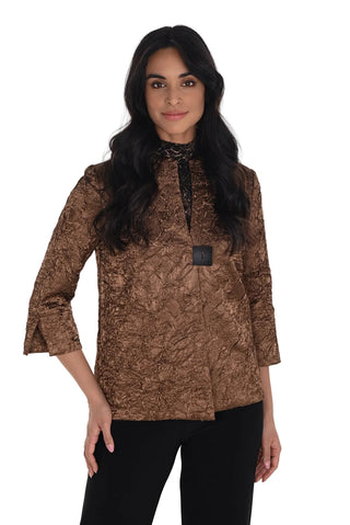Woman wearing a brown patterned top with a white background