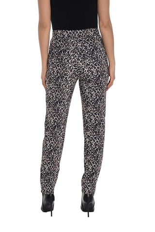 Person wearing black and white patterned pants on a white background