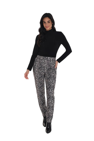 Woman wearing a black turtleneck and patterned pants on a white background