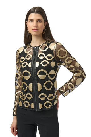 Woman wearing a black and gold patterned jacket on a white background