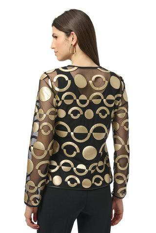 Woman wearing a black and gold patterned sheer top on a white background