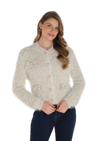 Woman wearing a textured beige sweater on a white background