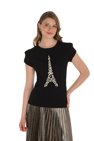 Woman wearing a black top with a decorative Eiffel Tower design on a white background