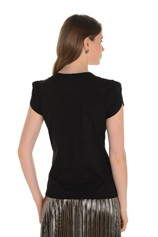 Woman wearing a black top with short sleeves on a white background