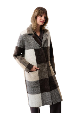 Woman wearing a checkered coat on a white background