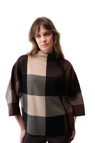 Woman wearing a checkered poncho with brown, beige, and gray pattern on a white background