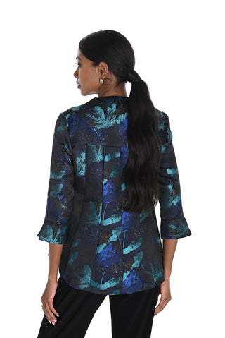 Woman wearing a blue and black patterned blouse on a white background