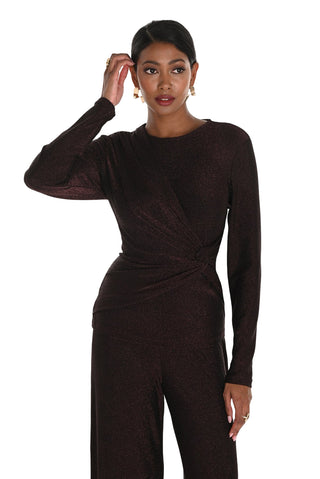 Woman wearing a brown long-sleeve jumpsuit on a white background