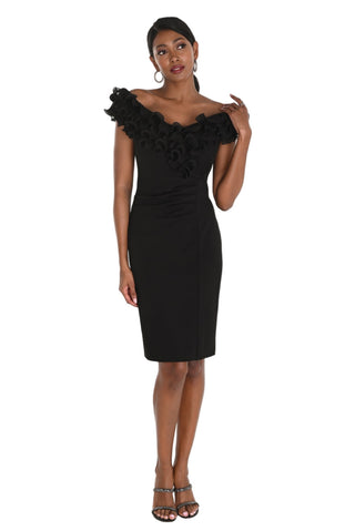 Woman wearing a black off-shoulder dress with ruffle details on a white background