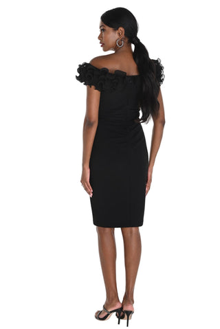 Woman wearing a black off-shoulder dress with floral details on a white background