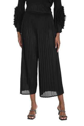 Person wearing a black pleated outfit on a white background