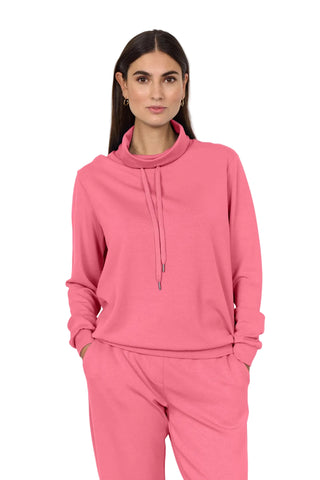 Woman wearing a pink outfit on a white background