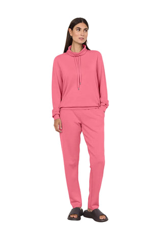 Woman wearing pink outfit on white background