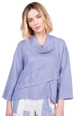 Woman wearing a light blue top with a white background