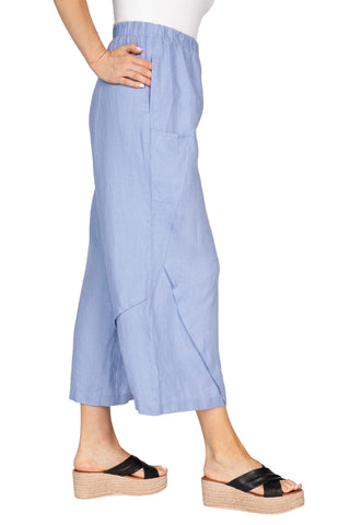 Person wearing a light blue skirt on a white background